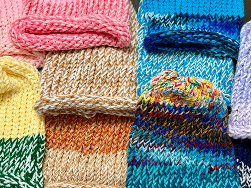 Collection of colorful hand-knitted beanie hats